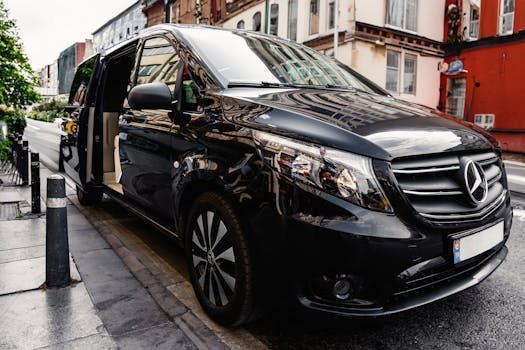 A stylish black Mercedes-Benz van parked on a bustling city street, showcasing luxury and modern design.