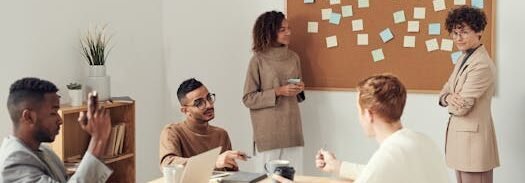 A diverse group of professionals collaborating in a modern office setting with a brainstorming session.